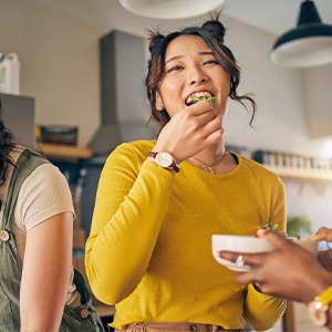 Group of friends enjoying meal in kitchen