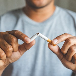 Closeup of patient breaking cigarette