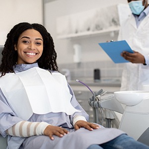 Woman smiling while sitting in treatment chair