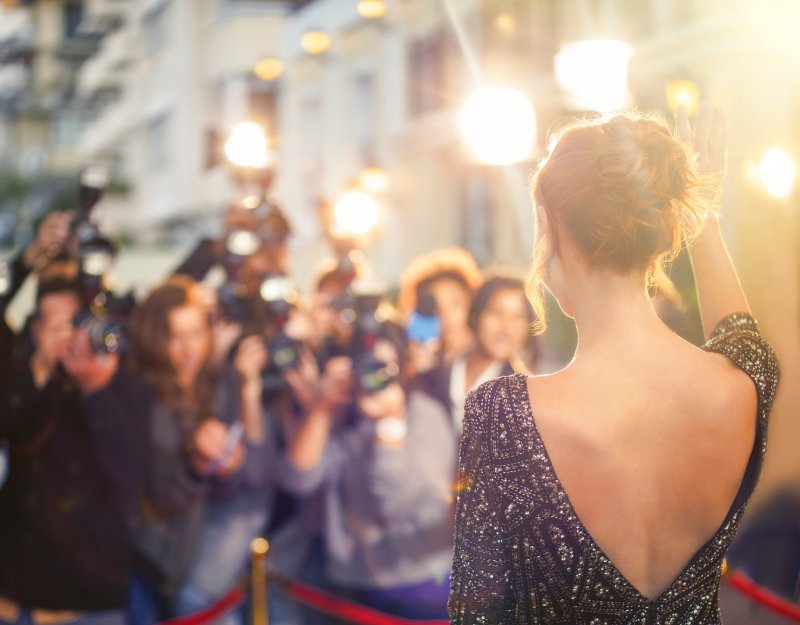 Celebrity with dental implants walking down red carpet
