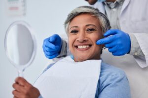 Woman smiling after cosmetic dental treatment